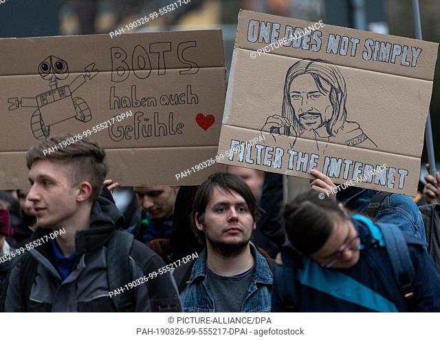 26 March 2019, Saxony, Dresden: Participants of a spontaneous demonstration protest against the copyright reform with signs in front of the CDU's regional...