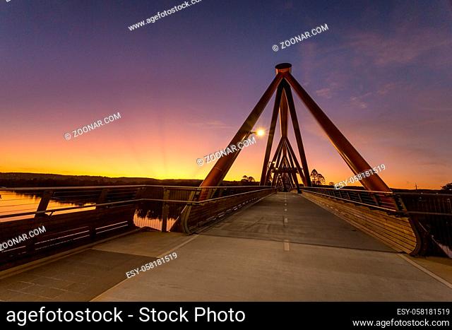 Sunrays rising from the setting sun at the Yandhai Nepean Crossing - a bridge spanning the Nepean River at Penrith