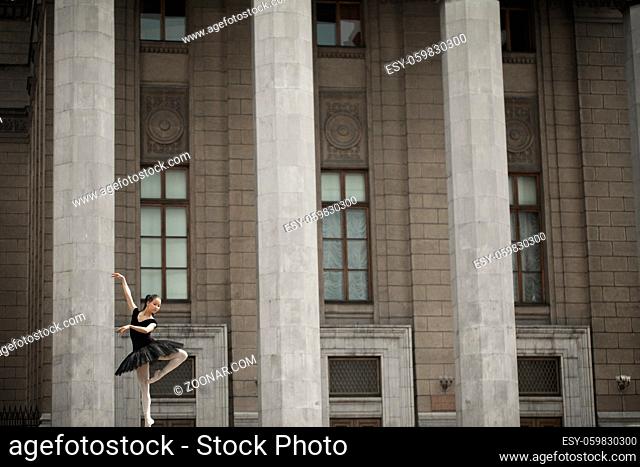 Girl ballerina flats standing on tiptoes on the street