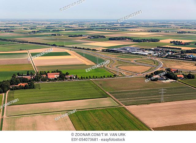 Aerial view Dutch agricultural landscape with farmhouses and a highway