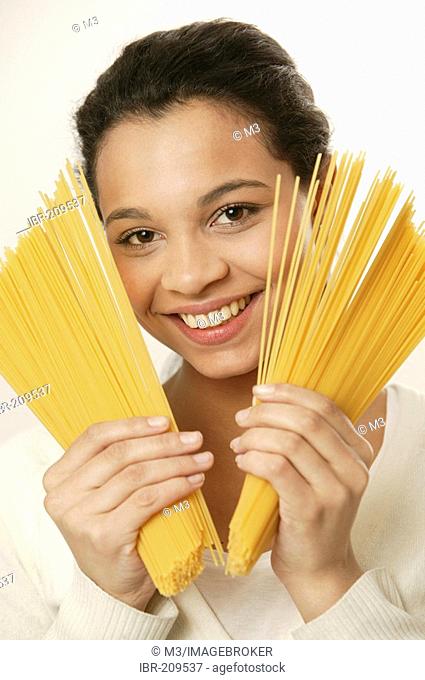 Young girl with spaghetti noodles