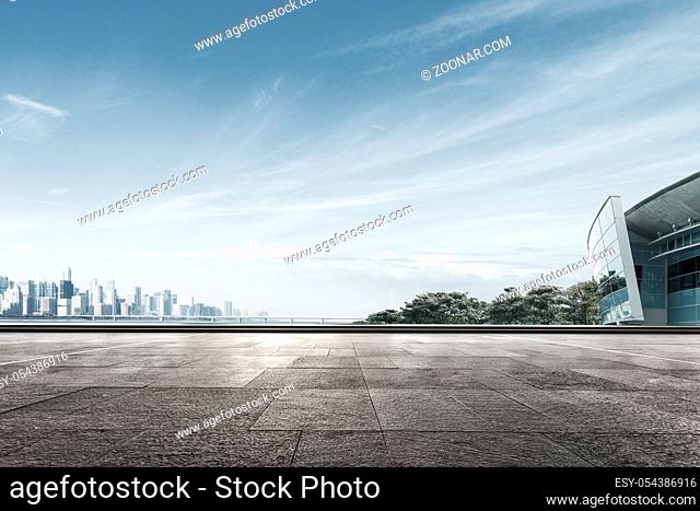 empty marble floor and cityscape of hangzhou in blue sky