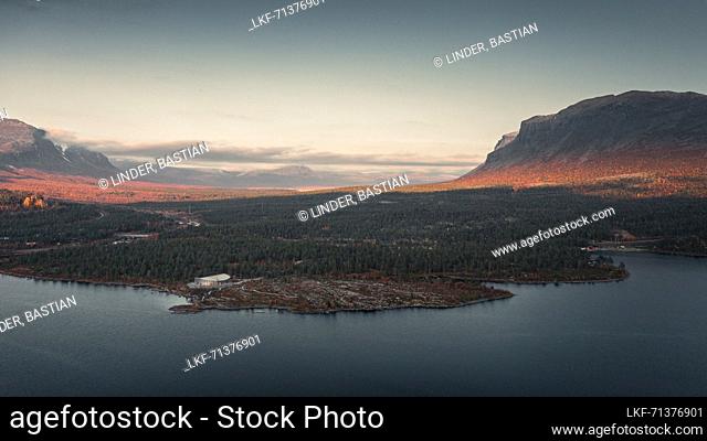 Landscape with mountains, lake and visitor center in Stora SjÃ¶fallet National Park in autumn in Lapland in Sweden from above