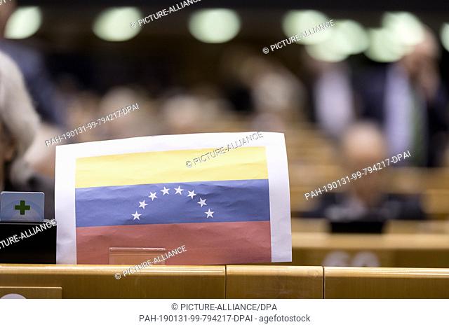 30 January 2019, Belgium, Brüssel: 30.01.2019, Belgium, Brussels: Spanish Member of the European Parliament Javier Nart add a Venezuelan flag during a session...