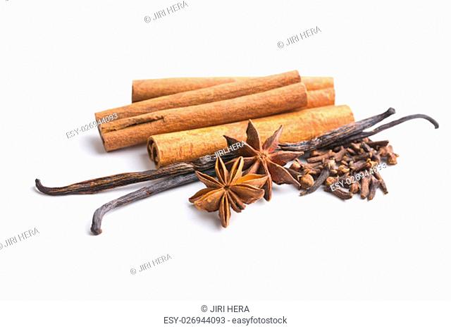 Vanilla, cinnamon, clove and anise star isolated on white background