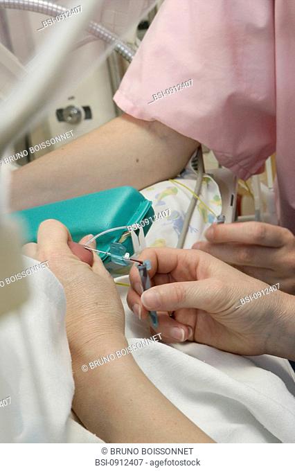 BLOOD SPECIMEN Photo essay at the hospital of Meaux 77, France. Department of neonatal resuscitation. A pediatric nurse is collecting blood from the heel of a...