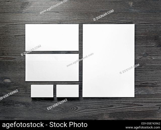 Blank corporate stationery on wood table background. Flat lay. Responsive design mock up