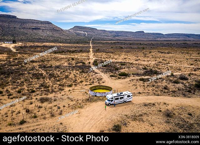 Aerial view of a parked RV next to a large metal container in desert landscape outside of Marfa, TX