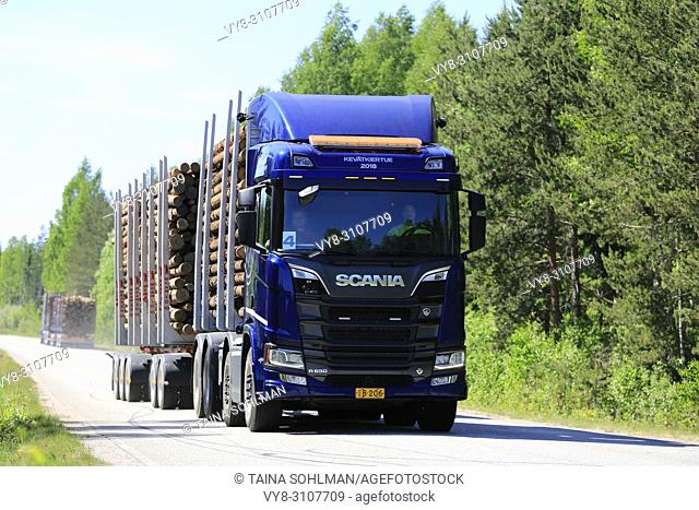 Blue Next Generation Scania R650 logging truck on test drive on rural road in spring during Scania Tour 2018 in Lohja, Finland - May 25, 2018