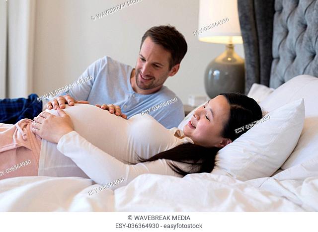 Couple feeling the presence of baby in stomach