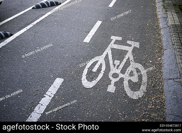 Bike lane sign painted on a street in Zaragoza, Spain