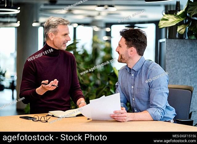 Business people discussing at table in meeting at work place