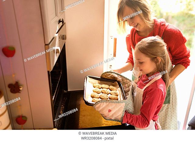 Mother and daughter looking at the baked cookies