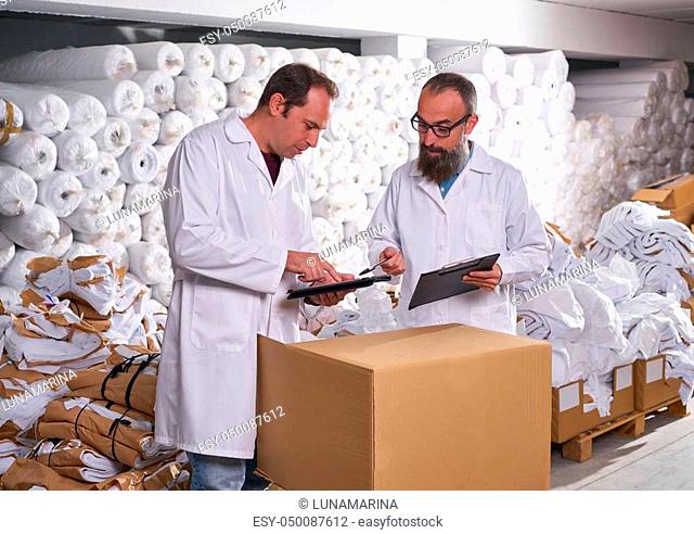 warehouse supervisor and manager men in fashion textile factory