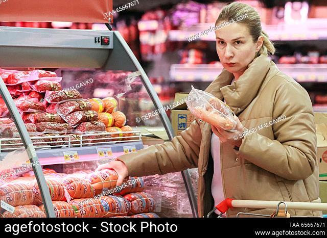 RUSSIA, SIMFEROPOL - DECEMBER 12, 2023: A woman shops for sausages in the 7M Beztsen superstore during the Christmas season. Sergei Malgavko/TASS