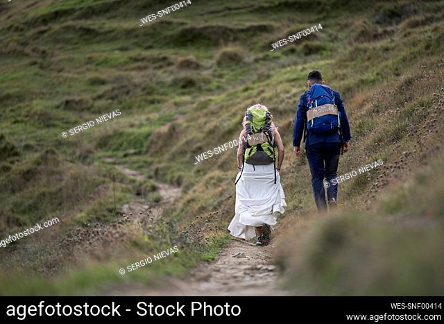 Bridal couple with climbing backpacks at Urkiola mountain, Spain