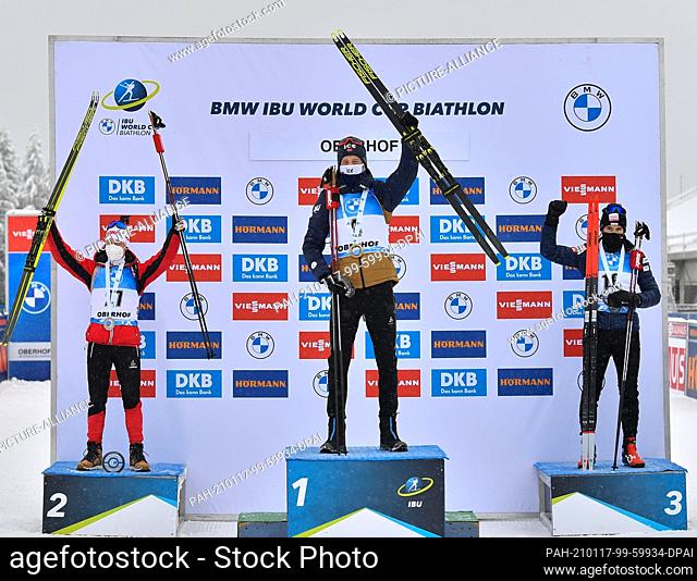 17 January 2021, Thuringia, Oberhof: Biathlon: Mass start 15 km, men. Winner Tarjei Boe (M) from Norway cheers at the award ceremony with Felix Leitner (l) from...