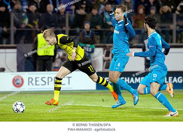 Dortmund's Marco Reus (L-R) vies for the Ball with Zenit's Domenico Criscito and Luis Neto during the UEFA Champions League round of 16 first leg soccer match...