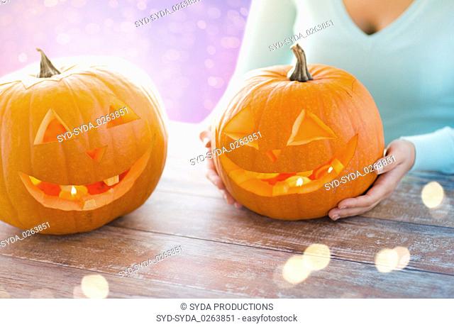 close up of woman with halloween pumpkins