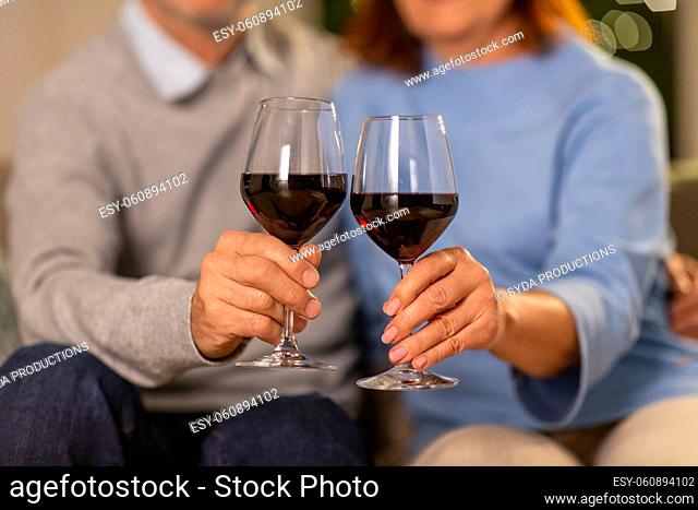 close up of senior couple with glasses of red wine