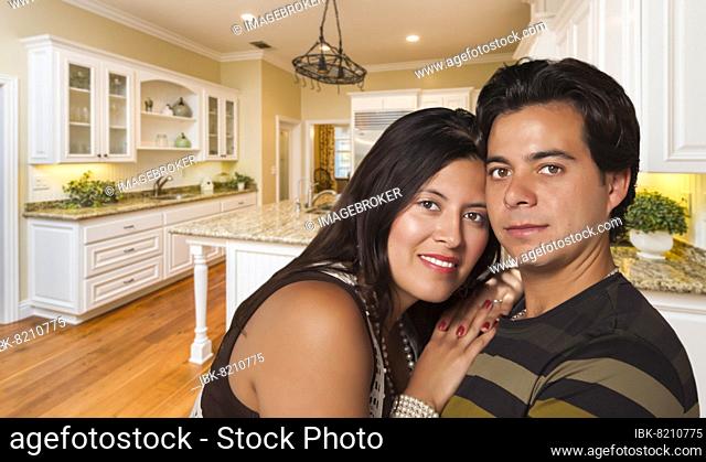 Affectionate hispanic couple inside custom kitchen interior