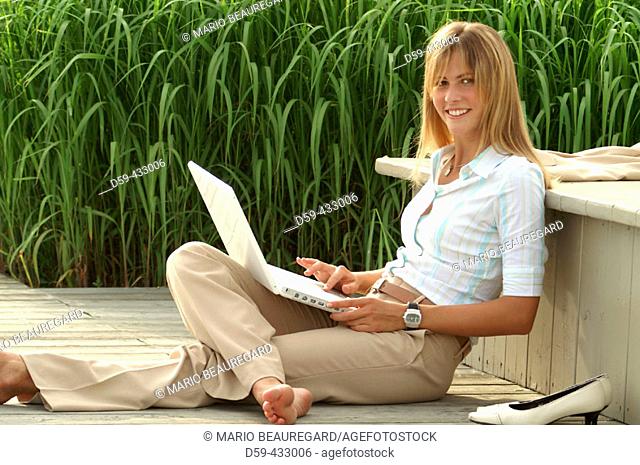 Young career woman, taking a break, with laptop computer