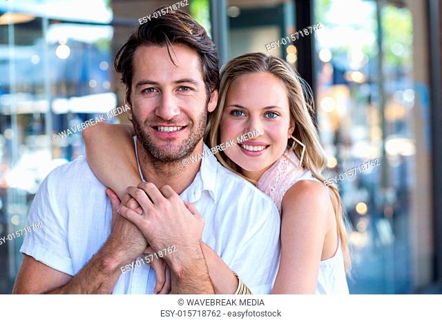 Smiling woman putting arm around her boyfriend