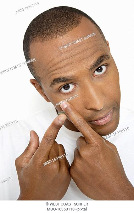 Man applying contact lens portrait