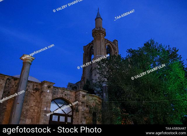 CYPRUS, FAMAGUSTA - DECEMBER 15, 2023: A view of the Lala Mustafa Pasha Mosque (the Cathedral of Saint Nicholas) at dusk