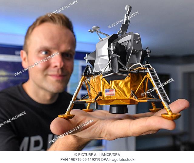 17 July 2019, Brandenburg, Eberswalde: Benjamin Stöwe, owner of the Star Trek Museum ""Raumschiff Eberswalde"", holds a model of the American Lunar Module...