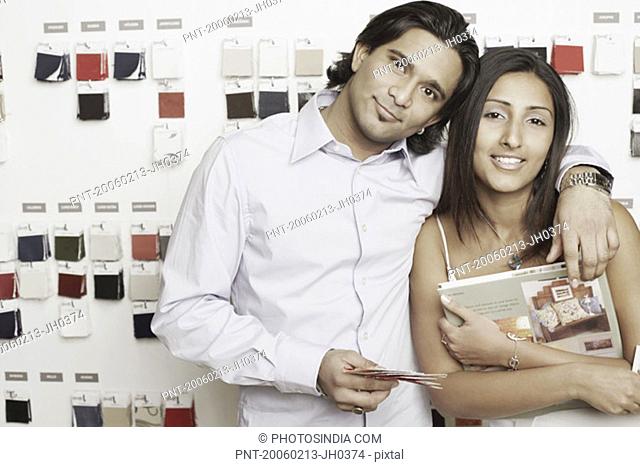 Portrait of a young couple standing at a fabric store