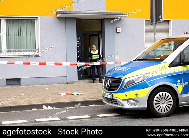 28 April 2023, North Rhine-Westphalia, Duisburg: A policewoman walks into a house in Duisburg. A 53-year-old woman suffered life-threatening injuries in a...