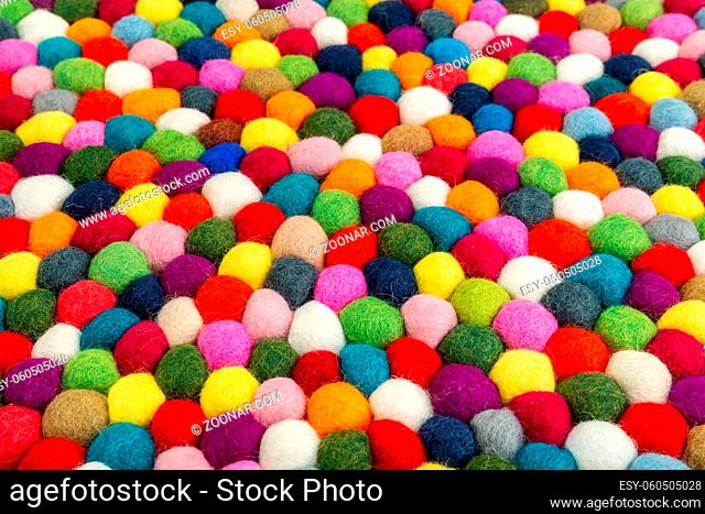 Multicolored felt ball rug detail, colorful texture