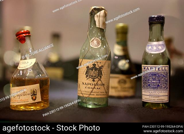 12 January 2023, Thuringia, Nordhausen: Miniature bottles lie in a glass display case at the traditional Nordhausen distillery