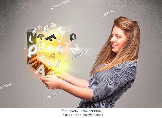 Young lady hoolding notebook with colorful abstract letters