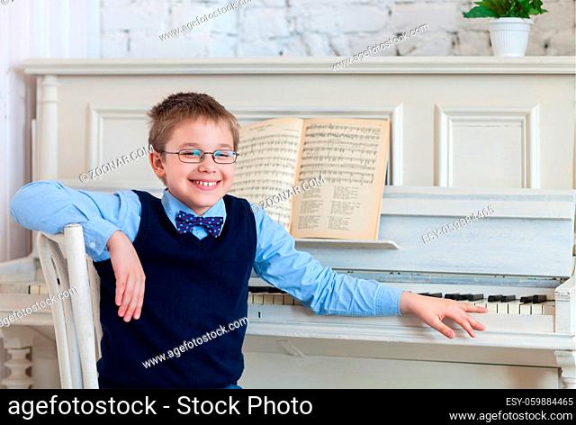 Little boy playing piano at home. Concept of music