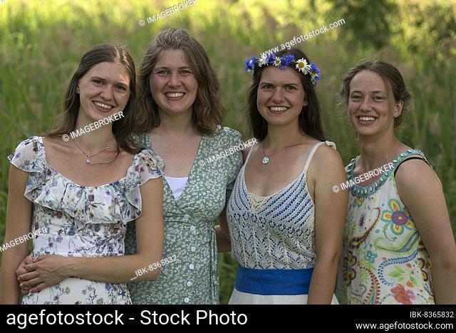 Four young, laughing woman in festive dresses, Mecklenburg-Western Pomerania, Germany, Europe