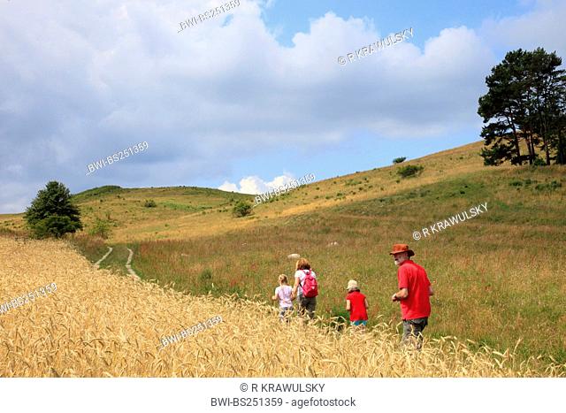 family walking in hilly landscape, Germany, Mecklenburg-Western Pomerania, Ruegen, Moenchgut