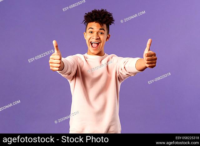 Portrait of satisfied young happy man think event was super cool, recommend use company service, assure in best quality, like and approve awesome product