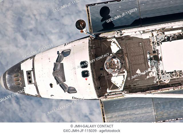 This partial view of the nose, crew cabin and forward part of the payload bay of the space shuttle Discovery was provided by an Expedition 26 crew member during...