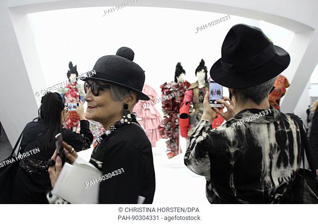 Female visitors take pictures of exhibits at the preview of the exhibition with which the MET will honor the japanese designer Rei Kawakubo