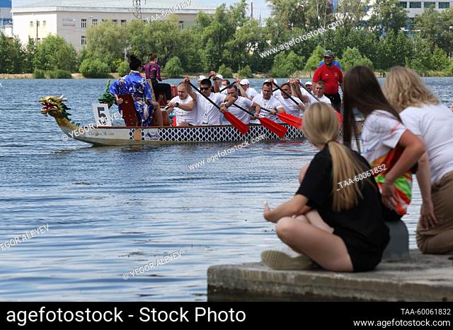 RUSSIA, KAZAN - JUNE 25, 2023: People watch a boat race at the Chinese Dragon Boat Festival titled Chinese Sabantui at Kazan's rowing sports center