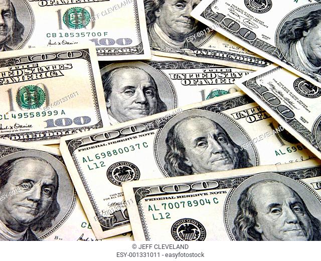 $100 Bills spread out in random display