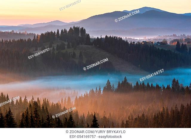The air. Early morning fog over the autumn slopes of Carpathian Mountains (Yablunytsia village and pass, Ivano-Frankivsk oblast, Ukraine)
