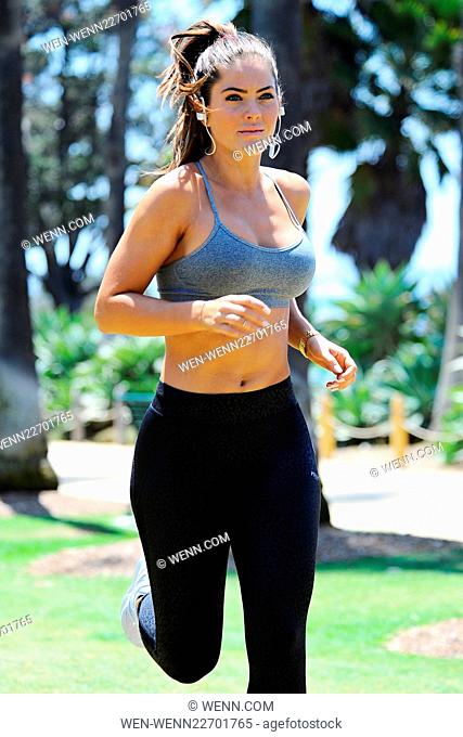 Shannon Decker from 'Hollywood Cycle' out jogging in Santa Monica. Shannon stops to do some stretching and plays with her mobile phone