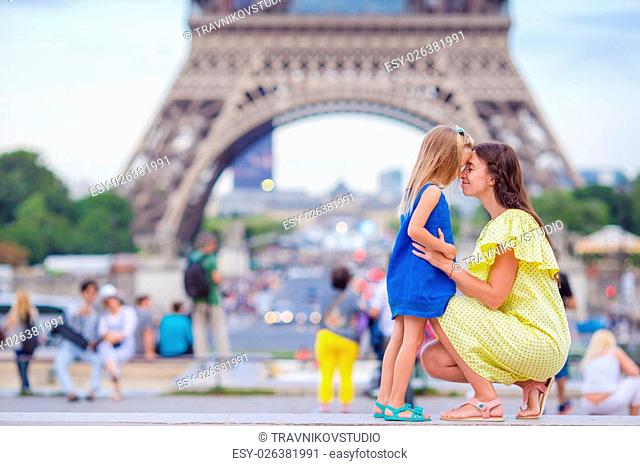 Happy mother and little adorable girl traveling in Paris near Eiffel Tower