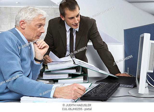 Colleagues looking into computer