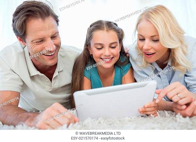 Girl and her parents using a tablet