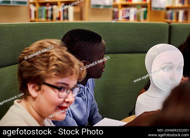 Young man sitting in library