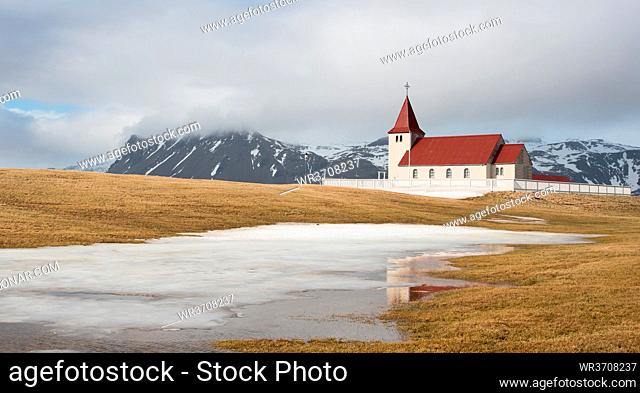 Traditional Icelandic church under reflected on a frozen lake at Snæfellsnes Peninsula in Iceland